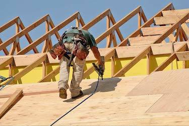 Professional custom builder installs roof