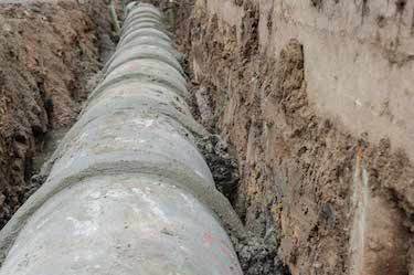 Large cement drainage pipe inside trench