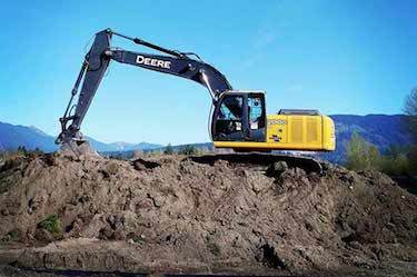 Large excavator on dirt pile