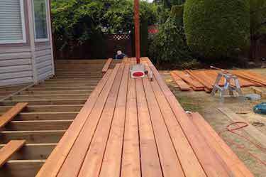 Deck builder installing new wood