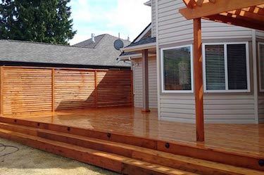 New shiny wooden deck with gazebo built in backyard