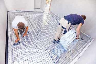 Renovation professionals install flooring