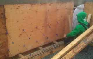 Construction worker installs custom form for concrete foundation