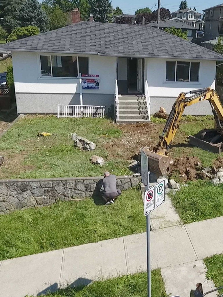 Excavator tears out concrete pathway