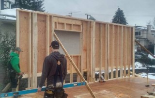 Framing crew installing wall at a house in Burnaby